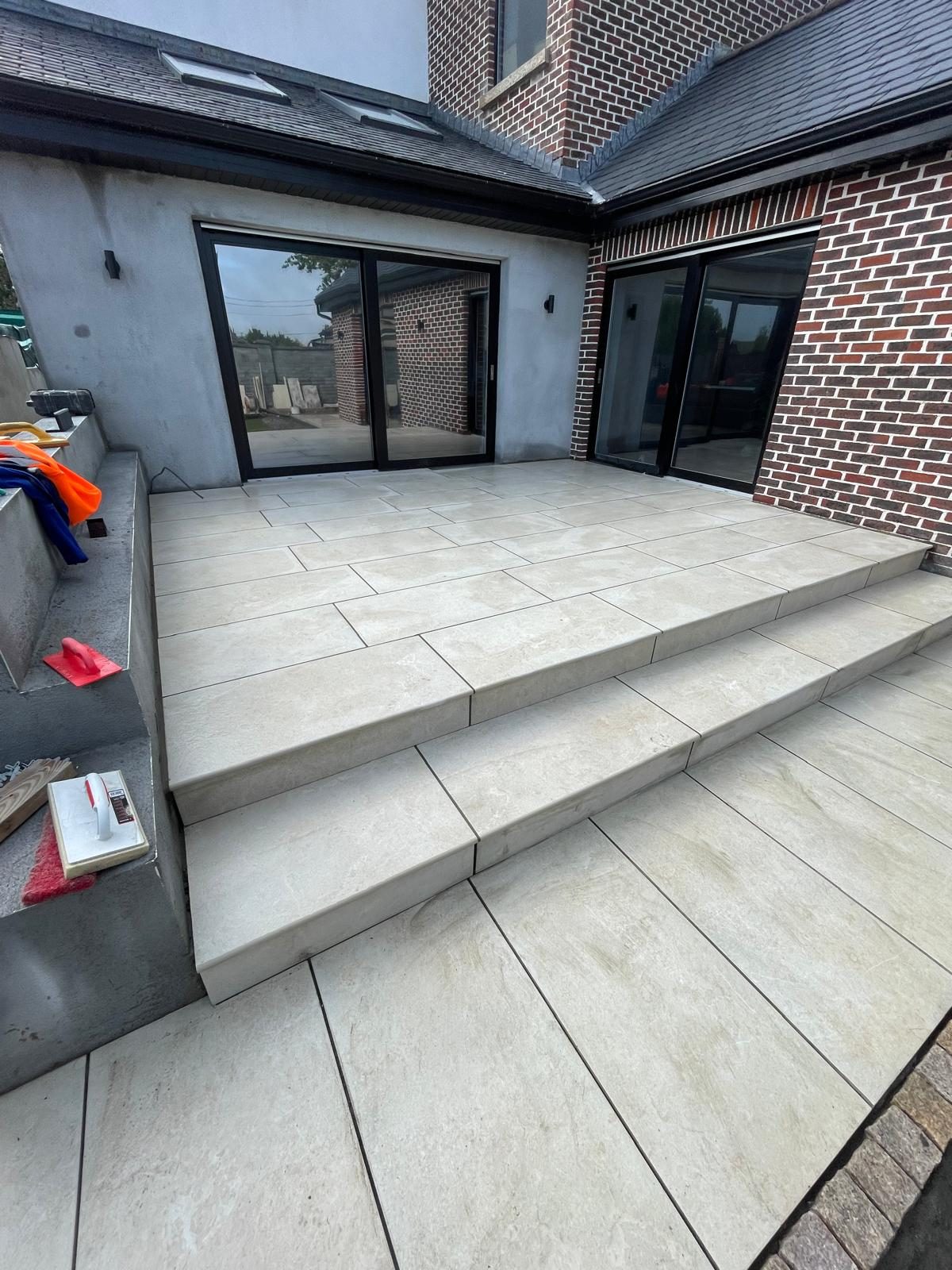 Slate patio with steps up to a back door