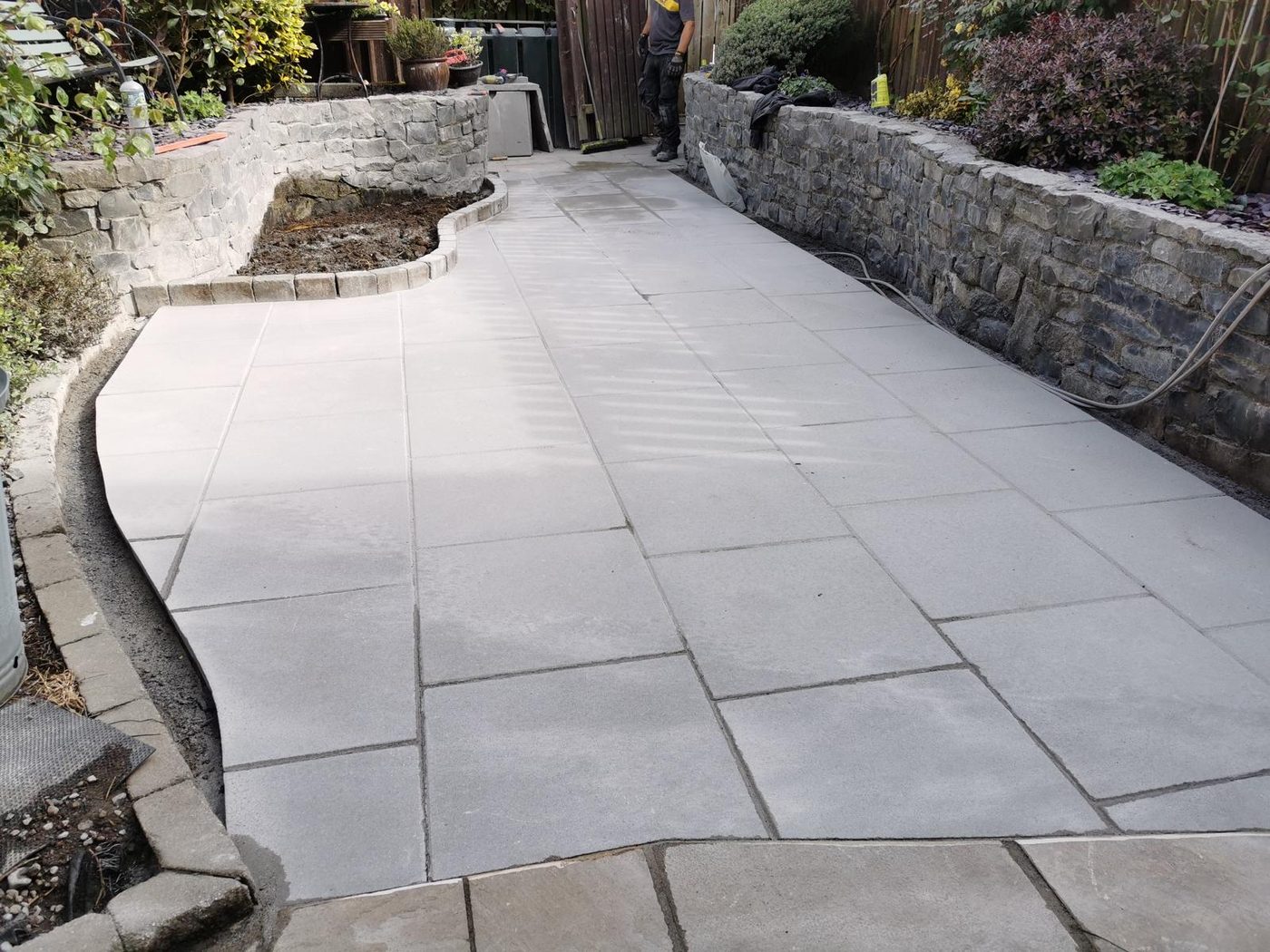 Large flagstone patio with garden wall